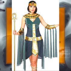 an egyptian woman dressed in costume and holding a staff with her hands on the hips