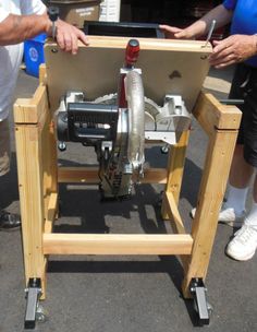 two people standing next to each other with a machine on it's back legs