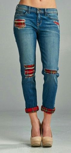 a woman in jeans with ripped knees and heels on her feet is posing for the camera