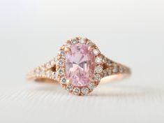 14K rose gold diamond halo split shank ring featuring an oval brilliant cut pink sapphire measuring 7.2 x 5 mm and weighing 1.20 ct (VS) . The sapphire is a beautiful light pink, very well cut with great sparkle. The center stone is flanked and surrounded by round brilliant cut diamonds with a total weight of 0.34 ct. (G/VS2,SI1). Size 6, can be sized up to 8. Additional charges apply on sizes 8+. Please convo me for pricing. *Ready to ship *SKU 13-101292 Peach Sapphire Rings, Gemstone Wedding Ring, Oval Halo Engagement Ring, Pink Sapphire Ring Engagement, Gemstone Wedding, Gemstone Wedding Rings, Sapphire Wedding Rings, Peach Sapphire, Half Eternity Wedding Band