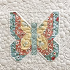 a close up of a quilted butterfly