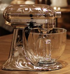 a glass mixer sitting on top of a wooden table