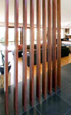 the room divider is made out of wooden slats