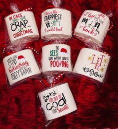 six christmas mugs are wrapped in clear cellophane and sitting on a red furnishing