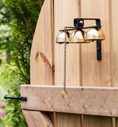 a wooden fence with bells hanging from it