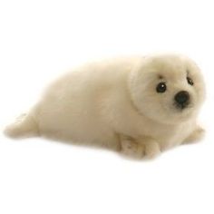 a small white seal sitting on top of a white floor