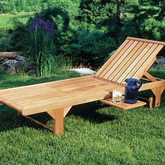 a wooden chaise lounge in the grass