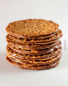 a stack of cookies with chocolate drizzled on top