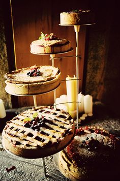 three tiered trays holding cakes and candles