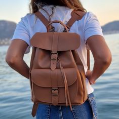 Real Leather Backpack Tobacco Color with adjustable straps. Perfect for gift. Stylish and durable.  Please note all natural leather products will darken with time. Dimensions of the bags: Small: 24×30×12 cm Med: 28×34×15 cm Large: 36×40×20 cm All Bags are made to order. If you like this bag, please see our full collection in the below link: https://www.etsy.com/shop/madammeshushu?section_id=17490770&ref=shopsection_leftnav_3 More on who we are Welcome to my store where you will find simple, comf Large Capacity Leather Backpack For School, Large Capacity Leather Backpack For Back To School, Casual Brown Leather Backpack For Students, Casual Leather Satchel For Students, Student Backpack With Adjustable Strap In Brown, Brown Student Backpack With Adjustable Strap, Brown Leather Backpack For Students, Softback Leather Backpack For Students, Back To School, Student Leather Softback Backpack For Back To School