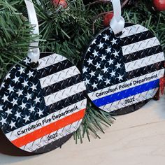 two patriotic ornament hanging from a christmas tree