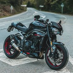 a black motorcycle parked on the side of the road