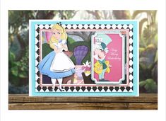 a card with an image of alice and wonderland on it, sitting on top of a table