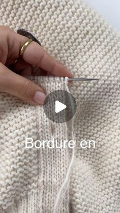 someone is stitching the side of a sweater with scissors