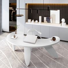 a white table sitting in the middle of a living room next to a wall mounted book shelf