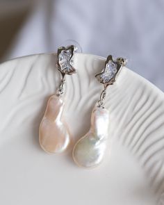 This gorgeous pair of Baroque Pearl earrings has unique asymmetrical shape, colours in white with hints of pink. The pearls have strong lustre and dangling under trendy design ear components. The pictures do not do this earrings justice Let this unique piece be a perfect accessory for your everyday adventures or a gift to the loved one.  Follow me on Instagram: cubic_jewels Baroque Pearl Earrings, Pearl Drop, Pearl Drop Earrings, Baroque Pearls, Unique Pieces, Jewelry Earrings Dangle, Pearl Earrings, Etsy Earrings, Dangle Drop Earrings