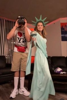 a man and woman dressed up as the statue of liberty