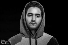 a black and white photo of a man wearing a hoodie