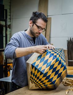 a man working on an object in his shop