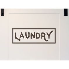 there is a laundry sign hanging on the wall