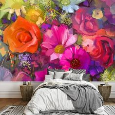 a bed sitting in front of a colorful flower wall mural on a wall next to a window