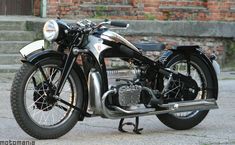 an old motorcycle is parked on the street