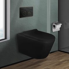 a black toilet sitting in front of a window next to a roll of toilet paper