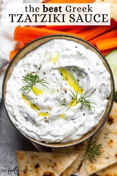 the best greek tzatziki sauce in a bowl surrounded by crackers and vegetables