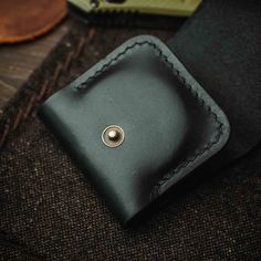 The Peso Pouch Mini is a challenge coins leather pouch for a daily carry. Are you ready for a swashbuckling adventure? With the Peso Pouch Mini, you can always take your favorite pirate treasure - be it 45mm or 40mm coins - on the go! Small enough to disappear in any front pocket, this slim yet sturdy leather pouch will keep your treasures safe as ya set sail. Features: - Hand stitched with linen thread- Hand finished edges- Awesome vintage look- Antique brass hardware In The Box:- The Peso Pouc Daily Carry, Linen Thread, Every Day Carry, Pirate Treasure, Digital Goods, Antique Brass Hardware, Best Wallet, Built To Last, Challenge Coins