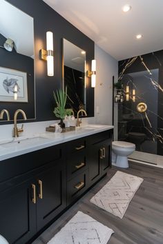 a bathroom with marble counter tops and black cabinets