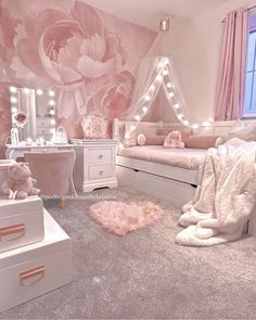 a bedroom decorated in pink and white with flowers on the wall