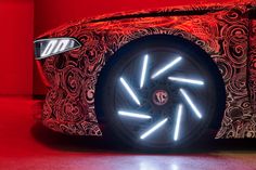 an artisticly designed car with bright lights on it