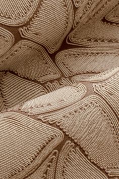 an up close shot of the fabric on a bed sheet that has been made to look like a pattern