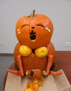 a pumpkin sitting on top of a cardboard box with its mouth open and eyes closed