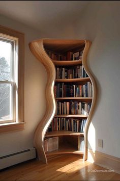 a curved book shelf in the corner of a room