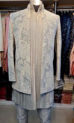 Art Dupion Raw Silk Swede Gray Velvet suit   Imported Fabric  Style : Ethnic Men Wear Top Details : Color -Gray Imported Valve Sherwani   Bottom -Gray Pant pajama  Top Fabric - Hand Embroidery  ( Achkan Style ) Indo-westerns style  Design : Achkan Style  Work Details : full  Embroidery over coat Size are : Very Small - 34inch Small 36inch Medium - 38inch Large - 40inch XLa-rge - 42inch 2XLarge - 44inch 3XLarge - 46inch 4XLarge - 48inch 5XLarge - 50inch 6XLarge - 52inch A little bit variation in colour may possible due to light effect, camera resolution and Monitor resolution. However you can ask for clear videos and pictures of the actual fabric which can be shared on whatsapp.  Note : We also ship matching mojari Indian Shoes) with this product on an extra cost. Please send us a message f Formal Festive Sets With Front Open, Front Open Kurta With Dupatta For Wedding, Formal Chikankari Embroidery Straight Kurta Bandhgala, Transitional Bandhgala With Chikankari Embroidery, Long Sleeve Bandhgala With Cutdana For Wedding, Wedding Outerwear With Dupatta For Eid, Bollywood Bandhgala With Chikankari Embroidery, Wedding Long Sleeve Bandhgala With Cutdana, Wedding Bandhgala With Cutdana And Long Sleeves