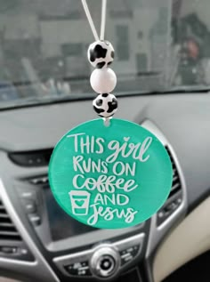 this girl runs on coffee and jesus keychain in the dashboard of a car