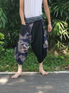 Item details Materials cotton,  hmong fabric, thai, japanese print FEATURE: Handmade Ethically, Breathable, Unisex, Comfortable to Wear & Stylish. MATERIAL: 100% Cotton, Handmade  Sizing : Tie Waist or Wrap pants Waist up to : 21 inch 44 inch ( 53.36 -111.75 cm ) Hip up to : 64 inch ( 142 cm ) Length     : 34 inch ( 78 Cm ) 1 Pocket COLOUR: Black Special Promotion  - Shipping by priority mail to USA Next all item get Free priority mail to USA  Non USA shipping by Air Mail registered. GENDER: M/F This beautiful samurai pants is unique & comfortable to wear. Handmade with very lovely pattern, it is easy to wear and great for many occasions. Unique handmade embroidered waist patches are made with Cotton fabric, each pair are a slight different which makes them an one-of-a-kind. One size fits Traditional Batik Print Summer Bottoms, Traditional Blue Harem Pants, Traditional Baggy Harem Pants, Traditional Pants With Pockets, Traditional Ankle-length Harem Pants With Elastic Waistband, Traditional Harem Pants For Yoga With Pockets, Traditional Yoga Harem Pants With Pockets, Traditional Long Harem Pants With Pockets, Traditional Wide Leg Harem Pants For Festivals