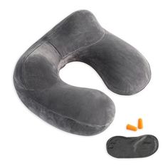 an inflatable travel pillow with ear plugs next to it on a white background