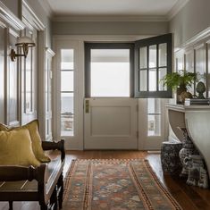 an entry way with a couch and rug on the floor