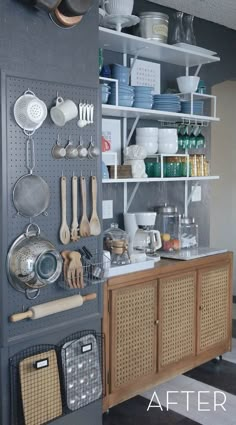 an organized kitchen with pots, pans and utensils hanging on the wall