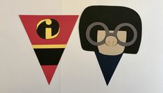 two pieces of paper cut out to look like superheros with glasses on their faces