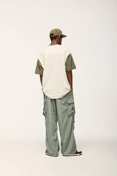 Elevate your streetwear with our Jet Cargo Pant. Vintage-inspired design, made from polyester and nylon, featuring midweight fabric and drawstring closure. SPECIFICATIONS Material: Polyester, Nylon Thickness: Midweight Waist Type: Mid Decoration: Pockets Closure Type: Drawstring Fabric Type: Broadcloth Urban Style Baggy Parachute Pants For Outdoor, Urban Relaxed Fit Parachute Pants, Urban Parachute Pants For Outdoor, Urban Cargo Style Parachute Pants For Streetwear, Green Drawstring Bottoms For Streetwear, Urban Streetwear Parachute Pants With Relaxed Fit, Urban Parachute Pants With Relaxed Fit For Streetwear, Urban Cotton Parachute Pants For Streetwear, Relaxed Fit Techwear Cargo Pants For Streetwear