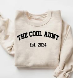 Custom The Cool Aunt Est. Sweatshirt, The Cool Aunt Shirt, Birthday Gift for Aunt, Christmas Gift for Aunt, New Aunt T Shirt, Auntie Hoodie How To Order? 1-) Please, check and review all photos, 2-) Choose your Size and Color, 3-) Click add to cart. You can go back to add more product 4-) Click "Proceed to check out" 5-) When you check out, you can add a note to seller for any request Unisex Adult T-Shirt * Unisex t shirt fits like a well-loved favorite, featuring a crew neck, short sleeves and Cricut Gifts For Aunt, Cotton Sweatshirt For Birthday In Winter, Cotton Sweatshirt For Winter Birthday, Casual Cotton Hoodie For Birthday, White Long Sleeve Hoodie For Birthday, Winter Birthday Sweatshirt With Letter Print, Winter Birthday T-shirt With Letter Print, Casual Winter Birthday Tops, Cotton Top For Birthday In Winter