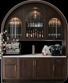 an arch - shaped bar with wine glasses and liquor bottles on the shelves, along with a coffee maker