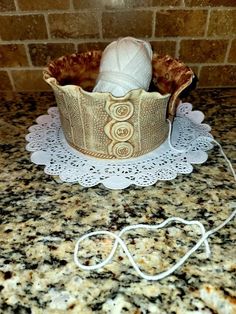 there is a basket on the counter with yarn in it and an electric cord attached to it