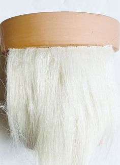 a close up of a white wig on a mannequin's head