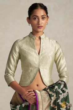 "Fit for royalty. This jacket-style blouse, made with the finest handwoven Banarasi brocade fabric is charming, versatile and regal. Leave everyone enraptured.\n\u00a0\n\n\n Color - A beautiful\u00a0shade of\u00a0Green\n\n Fabric - Pure Katan Silk\nNote - The blouse is made in standardized sizes as specified below\nPlease allow 10-12 business days for despatch.\u00a0\n\n" Luxury Brocade Blouse With Cutdana, Luxury Katan Silk Blouse With Cutdana, Luxury Unstitched Brocade Blouse Piece, Luxury Banarasi Silk Bollywood Blouse Piece, Luxury Brocade Tops With Zari Work, Luxury Ceremonial Katan Silk Blouse Piece, Luxury Banarasi Silk Blouse Piece In Pista Green, Luxury Katan Silk Blouse Piece With Cutdana, Unstitched Luxury Brocade Blouse Piece