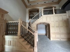 an empty room with stairs and railings