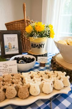 a table topped with lots of food next to a basket filled with flowers and other items